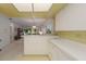 Kitchen with breakfast bar overlooking living room at 3500 El Conquistador Pkwy # 238, Bradenton, FL 34210