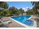 Inviting community pool with lounge chairs and lush landscaping at 3500 El Conquistador Pkwy # 238, Bradenton, FL 34210