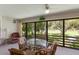 Dining area with a glass-top table and chairs overlooking the golf course at 3500 El Conquistador Pkwy # 238, Bradenton, FL 34210