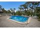 Community pool with plenty of lounge chairs for sunbathing at 3500 El Conquistador Pkwy # 238, Bradenton, FL 34210