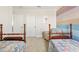 Twin bedroom with colorful striped wall and two beds at 2803 Butterfly Jasmine Trl, Sarasota, FL 34240