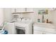 Convenient laundry room with washer, dryer, and utility sink at 2803 Butterfly Jasmine Trl, Sarasota, FL 34240
