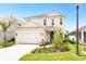 Two-story house with white siding, gray door, and a two-car garage at 2803 Butterfly Jasmine Trl, Sarasota, FL 34240