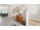 Bright entryway with tile floors, bench, and mid-century modern decor at 2803 Butterfly Jasmine Trl, Sarasota, FL 34240