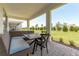 Relaxing covered patio with outdoor furniture and view of backyard at 2803 Butterfly Jasmine Trl, Sarasota, FL 34240