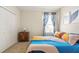 Cozy bedroom featuring a queen-size bed and a large window at 2803 Butterfly Jasmine Trl, Sarasota, FL 34240