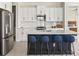 Modern kitchen with stainless steel appliances and a large island at 2803 Butterfly Jasmine Trl, Sarasota, FL 34240