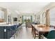 Open kitchen with island, stainless steel appliances, and a dining area at 2803 Butterfly Jasmine Trl, Sarasota, FL 34240