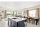 Open concept kitchen with island and view of backyard at 2803 Butterfly Jasmine Trl, Sarasota, FL 34240