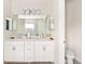 Double vanity bathroom with a large mirror and separate toilet area at 2803 Butterfly Jasmine Trl, Sarasota, FL 34240