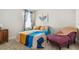 Bright bedroom with a comfortable bed and a relaxing armchair at 2803 Butterfly Jasmine Trl, Sarasota, FL 34240