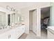 Double vanity bathroom with walk-in shower and closet at 2803 Butterfly Jasmine Trl, Sarasota, FL 34240