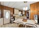 Kitchen features a dining area, white table, and wood paneling at 3410 Spanish Oak Ter, Sarasota, FL 34237