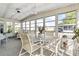 Spacious sunroom with wicker furniture and glass-top table at 3410 Spanish Oak Ter, Sarasota, FL 34237