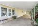 Covered carport with access to the home and landscaping at 3410 Spanish Oak Ter, Sarasota, FL 34237