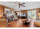 Bright living room with hardwood floors, large windows, and access to a screened porch at 3410 Spanish Oak Ter, Sarasota, FL 34237