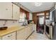 Galley style kitchen with yellow countertops and plenty of storage at 3410 Spanish Oak Ter, Sarasota, FL 34237