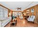 Spacious living room featuring hardwood floors, comfy seating, and a ceiling fan at 3410 Spanish Oak Ter, Sarasota, FL 34237