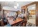 Cozy dining area with wood table and chairs, open to living room at 3410 Spanish Oak Ter, Sarasota, FL 34237