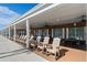 Relaxing community patio with rocking chairs and picnic tables at 3410 Spanish Oak Ter, Sarasota, FL 34237