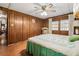 Bedroom with wood-paneled walls and a queen-size bed at 3410 Spanish Oak Ter, Sarasota, FL 34237