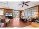 Living area with hardwood floors, comfy seating, and sliding glass doors leading to patio at 3410 Spanish Oak Ter, Sarasota, FL 34237