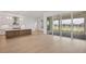 Modern kitchen island with white cabinets and black appliances at 1217 Blue Shell Loop, Sarasota, FL 34240