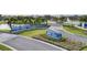 Community entrance with signage and landscaping, featuring a pond and fountain at 1217 Blue Shell Loop, Sarasota, FL 34240