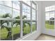 Sunlit living room featuring stunning water and landscape views from large windows at 1217 Blue Shell Loop, Sarasota, FL 34240