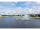Aerial view of a lakefront community with a fountain at 1217 Blue Shell Loop, Sarasota, FL 34240