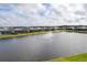 Aerial view of waterfront homes with a community fountain at 1217 Blue Shell Loop, Sarasota, FL 34240