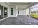 Spacious screened patio with paver surface and view of lake at 1217 Blue Shell Loop, Sarasota, FL 34240