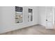 Spacious home office with hardwood floors and two large windows at 1217 Blue Shell Loop, Sarasota, FL 34240