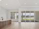 Open concept living room and kitchen, with water view from sliding doors at 1217 Blue Shell Loop, Sarasota, FL 34240