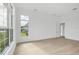 Bright bedroom with hardwood floors and large windows overlooking the backyard at 1217 Blue Shell Loop, Sarasota, FL 34240