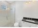 Modern bathroom with a walk-in shower and dark vanity at 1217 Blue Shell Loop, Sarasota, FL 34240