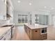 Modern kitchen with large island, stainless steel appliances and white cabinets at 1217 Blue Shell Loop, Sarasota, FL 34240