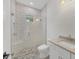 Clean bathroom with a walk-in shower, built-in seat, and hexagon floor tile at 1217 Blue Shell Loop, Sarasota, FL 34240