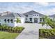White two-story house with gray roof and paver driveway at 1217 Blue Shell Loop, Sarasota, FL 34240