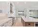Eat-in kitchen with island, stainless steel appliances, and white cabinets at 1217 Blue Shell Loop, Sarasota, FL 34240