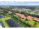 An aerial view of homes with red roofs, lush landscaping, and scenic ponds surrounding the properties at 6384 Draw Ln # 38, Sarasota, FL 34238