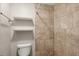 Bathroom with tiled walk-in shower and built-in shelving at 6384 Draw Ln # 38, Sarasota, FL 34238