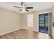 Bedroom with fan, wood floors, neutral walls, with sliding glass doors leading to a screened porch at 6384 Draw Ln # 38, Sarasota, FL 34238
