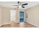 Bedroom with fan, wood floors, neutral walls, with sliding glass doors leading to a screened porch at 6384 Draw Ln # 38, Sarasota, FL 34238