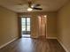 Bedroom features updated floors, a ceiling fan, a walk-in closet, and an enclosed porch at 6384 Draw Ln # 38, Sarasota, FL 34238
