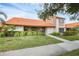 Exterior of home with a sidewalk leading up to the front door, surrounded by green landscaping and plants at 6384 Draw Ln # 38, Sarasota, FL 34238