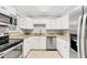 Well-lit kitchen with white cabinetry, stainless steel appliances, and granite countertops at 6384 Draw Ln # 38, Sarasota, FL 34238