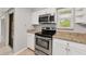 The kitchen features granite countertops, stainless steel oven and microwave, and a modern design at 6384 Draw Ln # 38, Sarasota, FL 34238