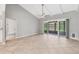 Spacious living room with tile flooring, vaulted ceilings, and sliding doors leading to lanai at 6384 Draw Ln # 38, Sarasota, FL 34238