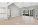 Open living room featuring tile flooring, neutral walls, ceiling fan and access to lanai at 6384 Draw Ln # 38, Sarasota, FL 34238